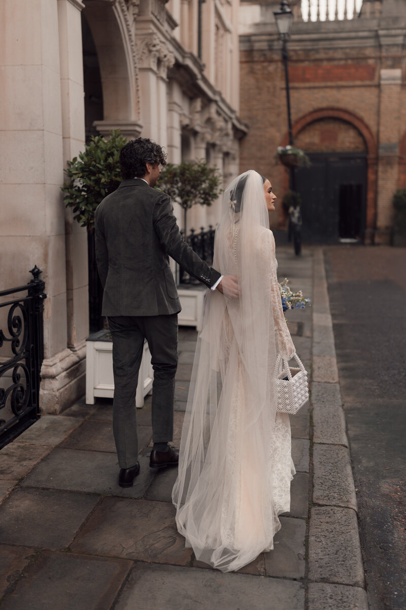 A portrait view of Janice and Bertie embracing at a garden wedding ceremony in the Cotswolds