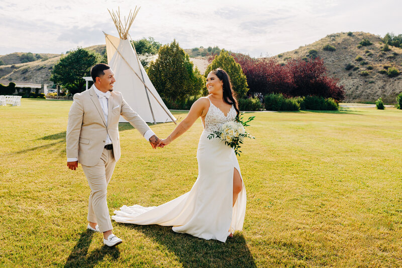 Western Montana bride and groom holding hands and walking together