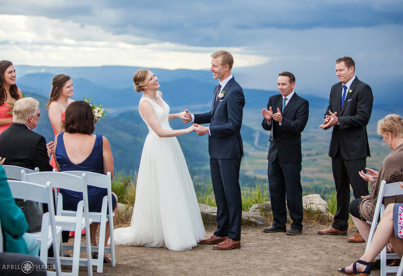 Couple laughs after their first kiss at their wedding ceremony at the Vista Overlook during summer in Steamboat Springs