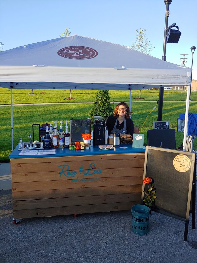 Rachel operating a coffee cart at a Farmers Market