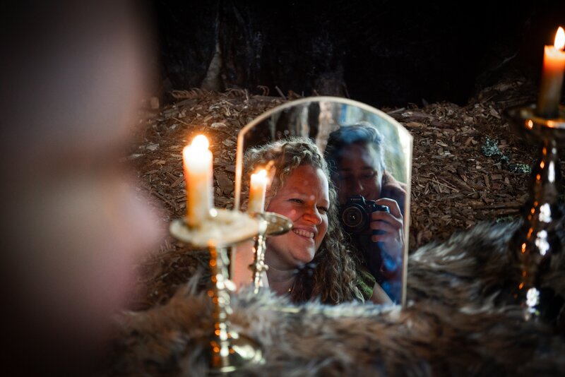 Oracle Business Witch Rachael Maddox, in front of a mirror with candles glowing, sharing the process that has yielded consistent success, big service and financial abundance. 
