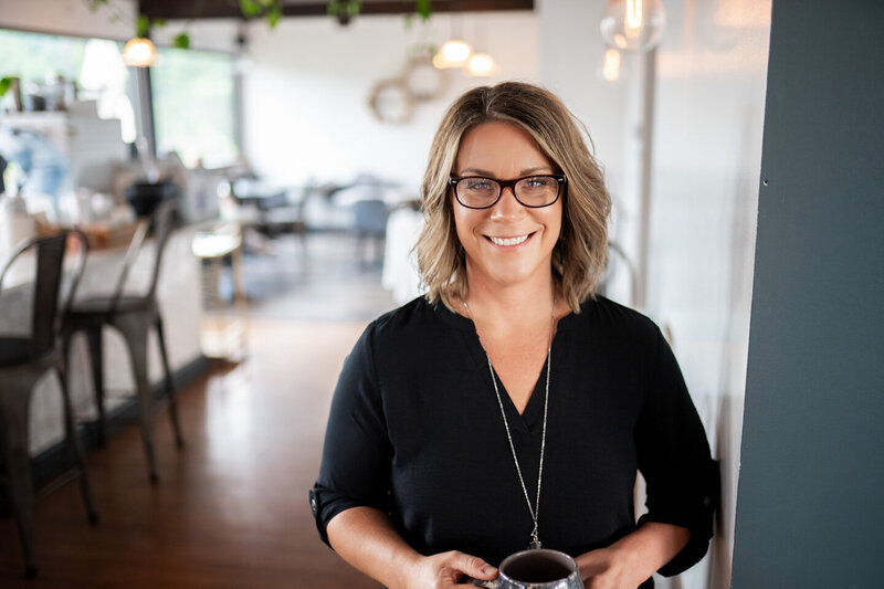 Jen Heller smiling black shirt in a coffee shop