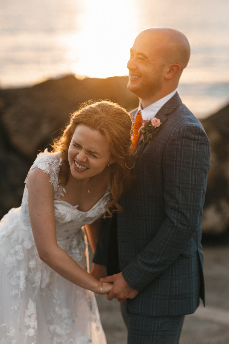 Couple laughing at sunset at a North Devon beach