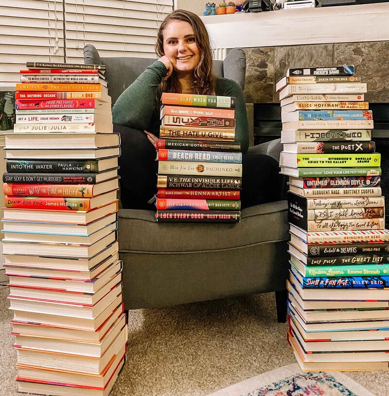 Woman sitting in reading chair with books