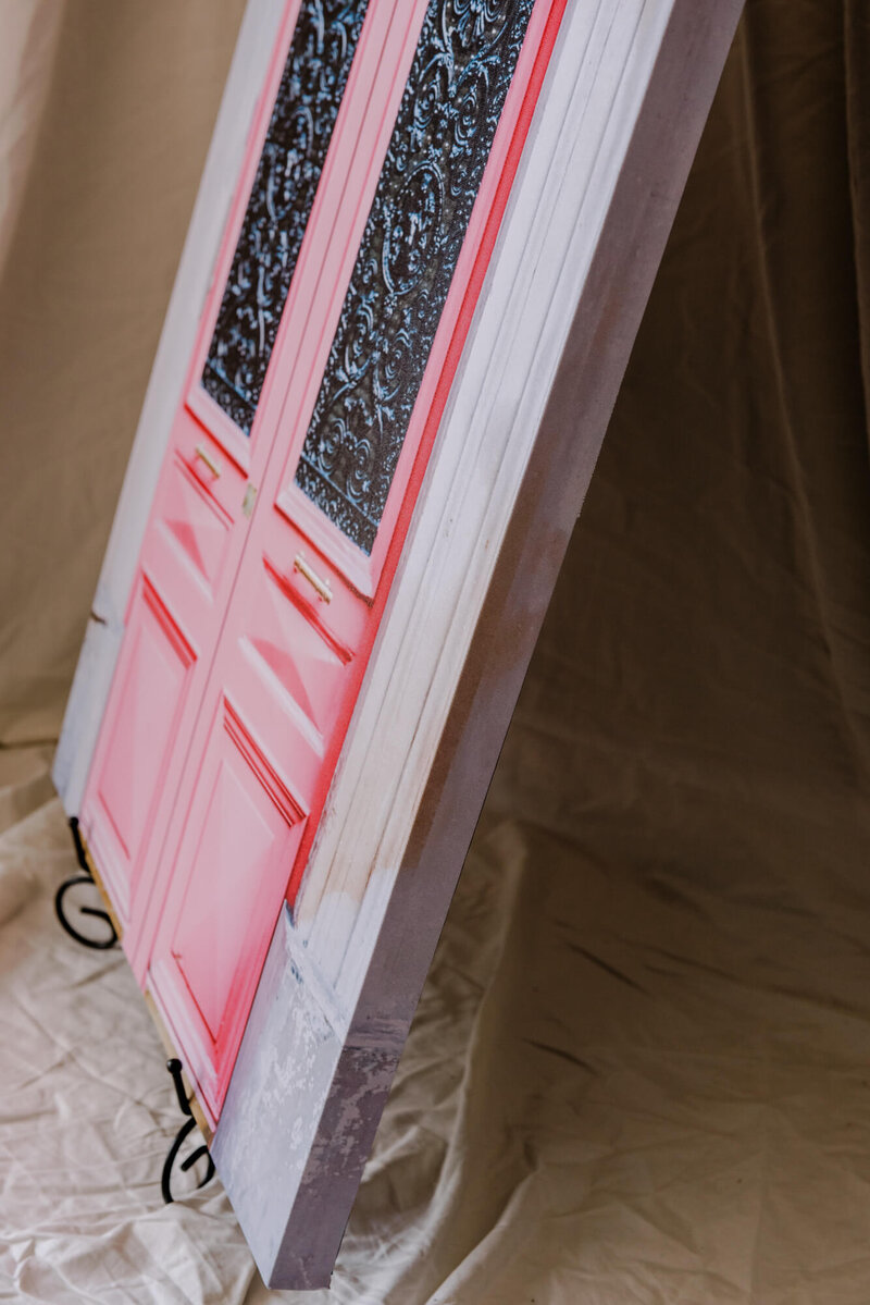a pink door in paris in the 9th arrondissement by the pigalle metro station