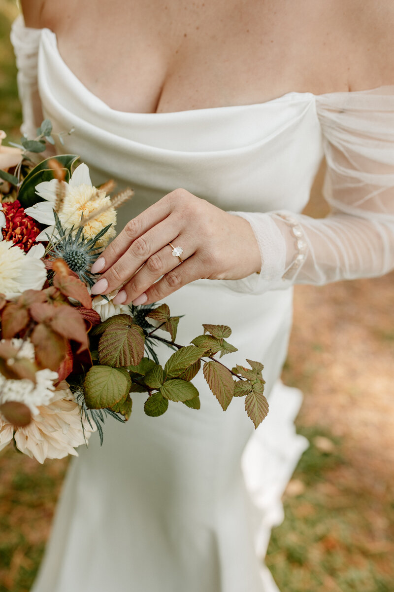 Lush Fall bridal bouquet featuring blue thistle, carnations, ivy, and carnations