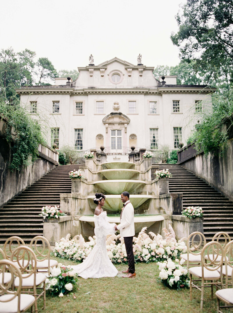 Stunning couple stand amidst their wedding ceremony setting at the Swan House in Atlanta