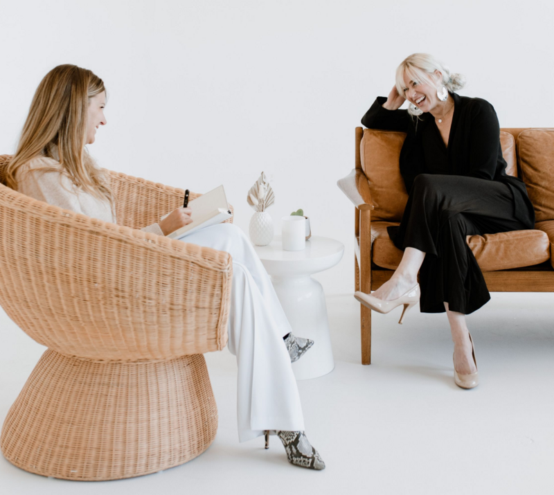 Peak Interactive Wellness therapists in Denver and Greenwood Village sitting in modern chairs, engaging in supportive conversation that reflects personalized, whole-person mental health care.