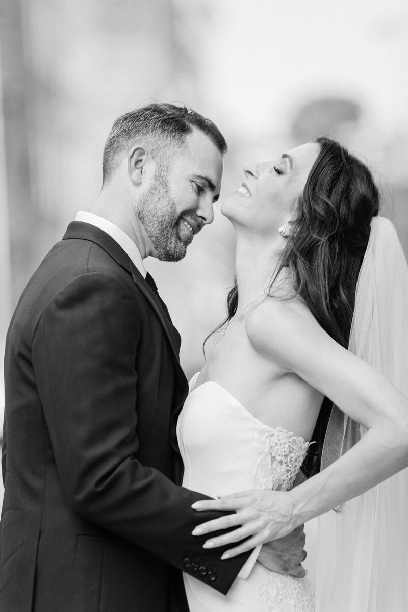 Photo of Bride and Groom Laughing with each other in black and white