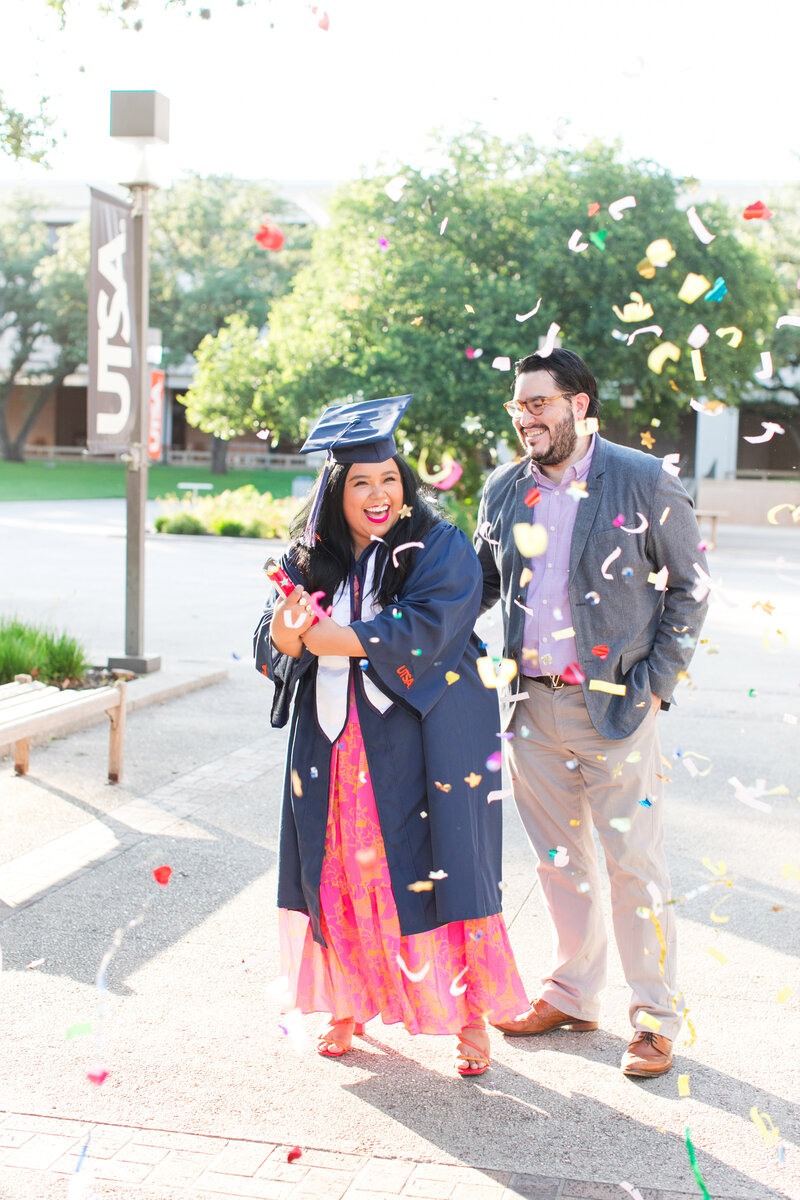 couple celebrating with confetti  after graduation