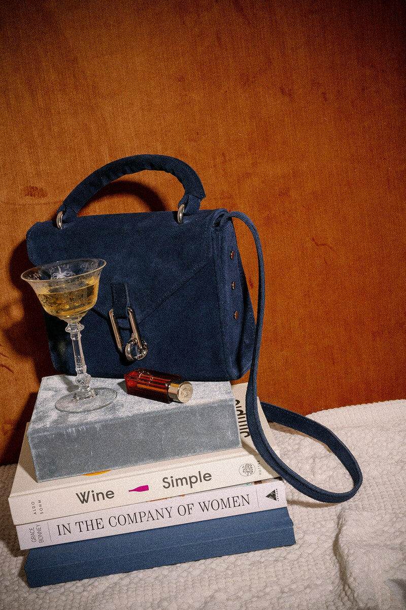 cocktail in front of a blue handbag