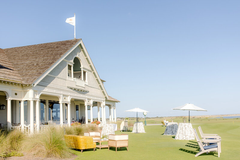 Outdoor venue with a green lawn and luxurious beach house