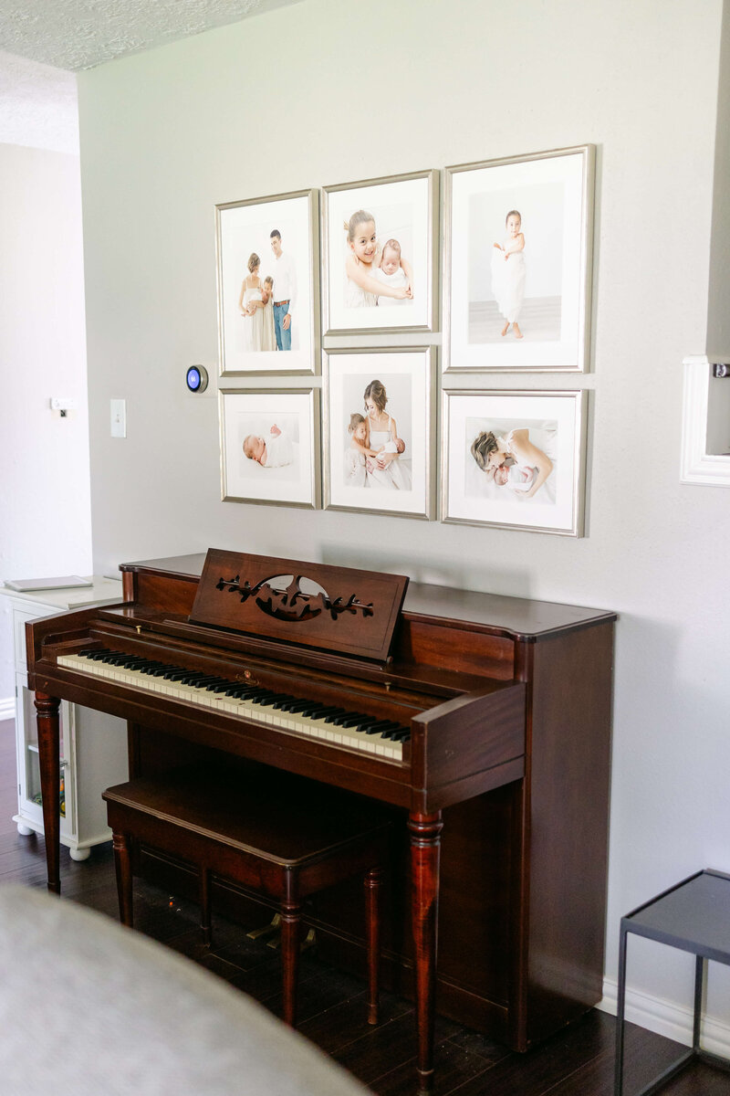 gallery wall hanging above piano in Houston family home