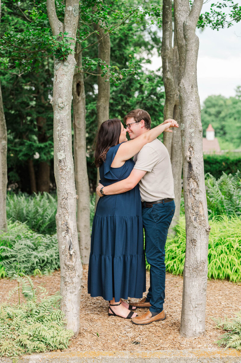 Engaged couple embrace for their engagement session at Yew Dell Botanical Gardens