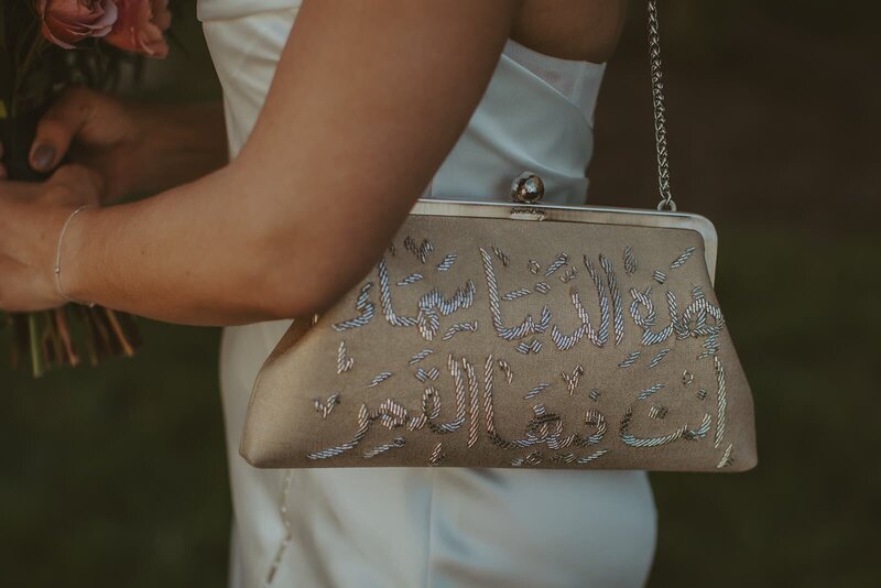 up close of bride in wedding dress with vintage inspired clutch purse