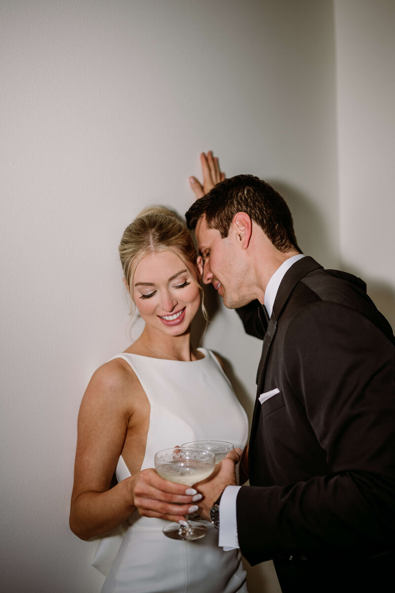 Image of bride and groom drinking wine while groom