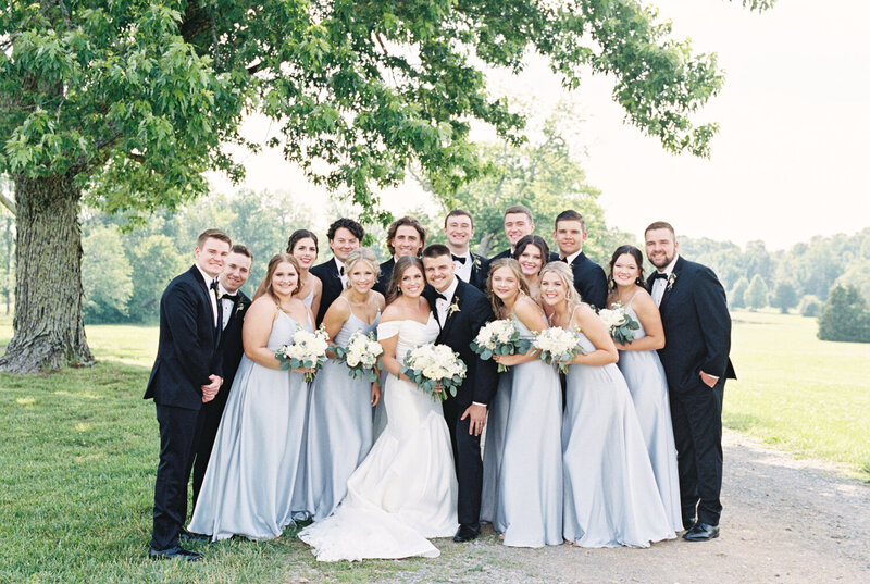 A wedding party gather together joyfully by Chattanooga wedding photographer Kelsey Dawn Photography