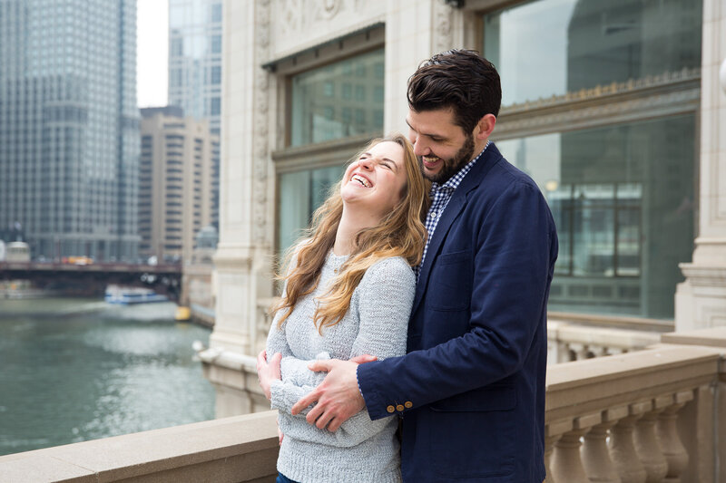 couple on michigan avenue hugging  after surprise proposal in downtown chicago
