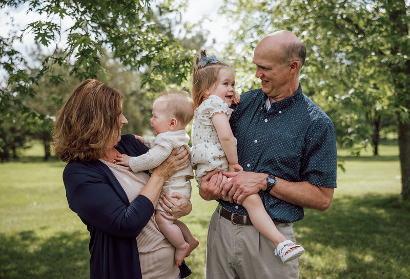 Portrait of grandparents holding their grandchildren taken during an extended family portrait session in Farmington, Missouri. 