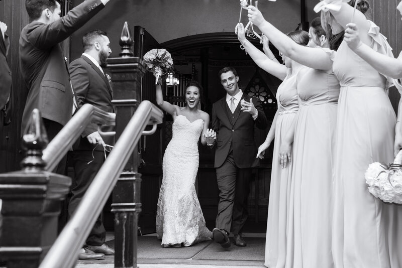 Cleveland bride and her bridesmaids shares laughs and memories on her wedding day, behind The Old Courthouse located in Cleveland Ohio. Photographed by Aaron Aldhizer