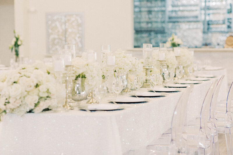 Beautiful wedding reception with white flower arrangements and candles