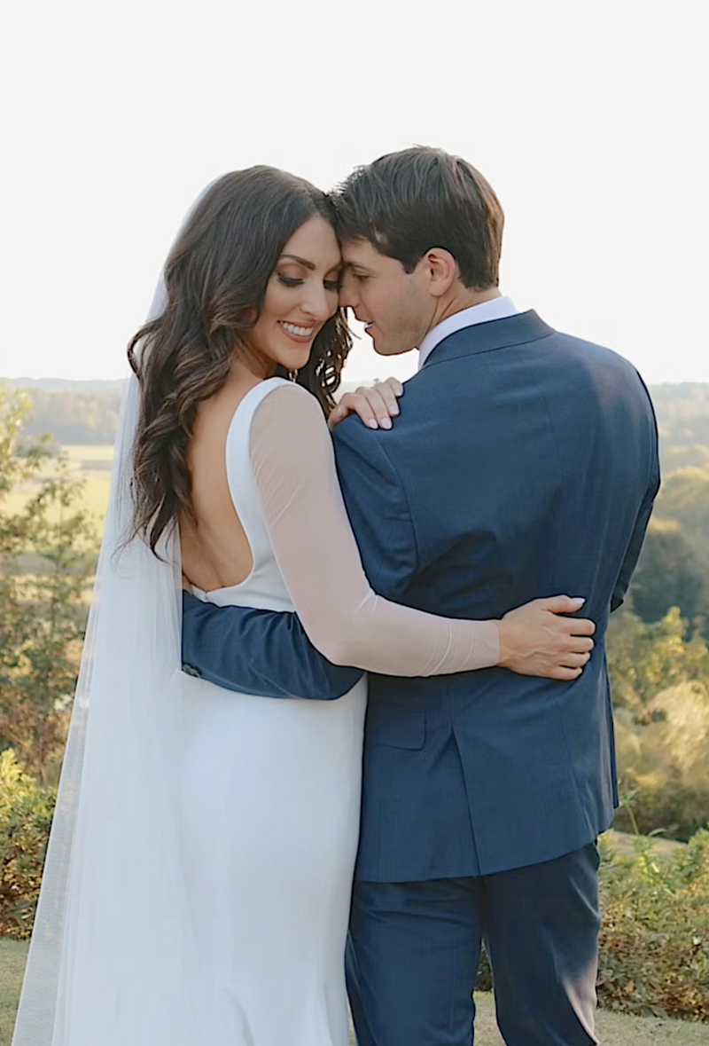 Groom holds bride after getting married outdoors in Georgia