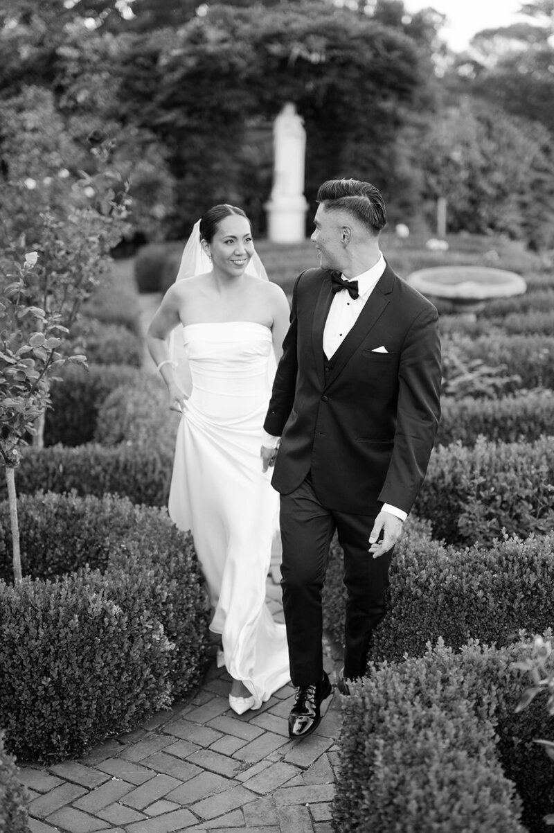 Bride and Groom walk through the garden at Kohl Mansion, a San Francisco wedding venue.