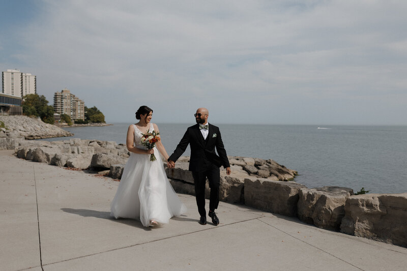 Couple running away for sunset during their wedding reception in Ontario
