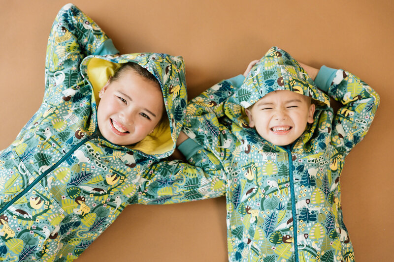 two young boys posing in hoodies