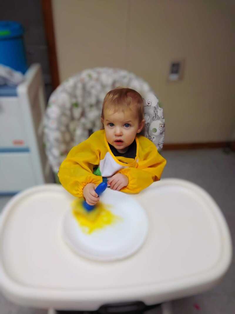 Toddler Doing Crafts in High Chair CPC Albuquerque Childcare