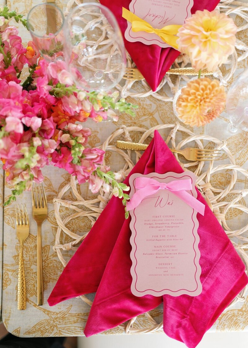 vibrant fuschia wedding details including dinner menu and gold cutlery with flowers in shades of pink for minneapolis wedding