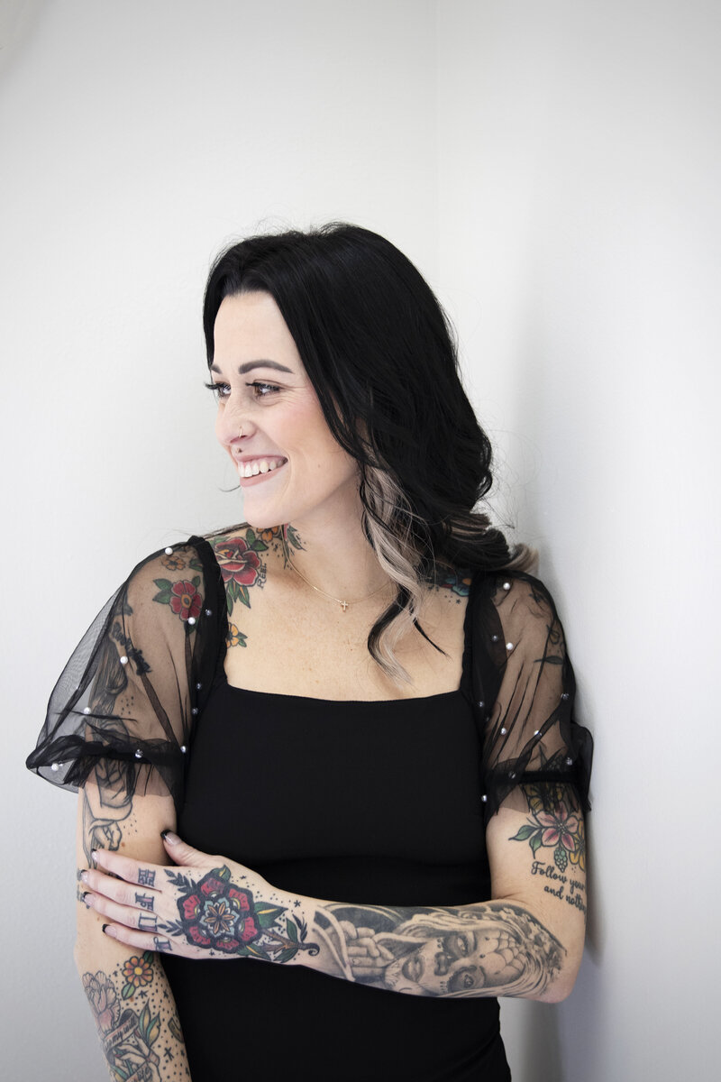 Photo of business owner Kat smiling with her head turned slightly to the side.