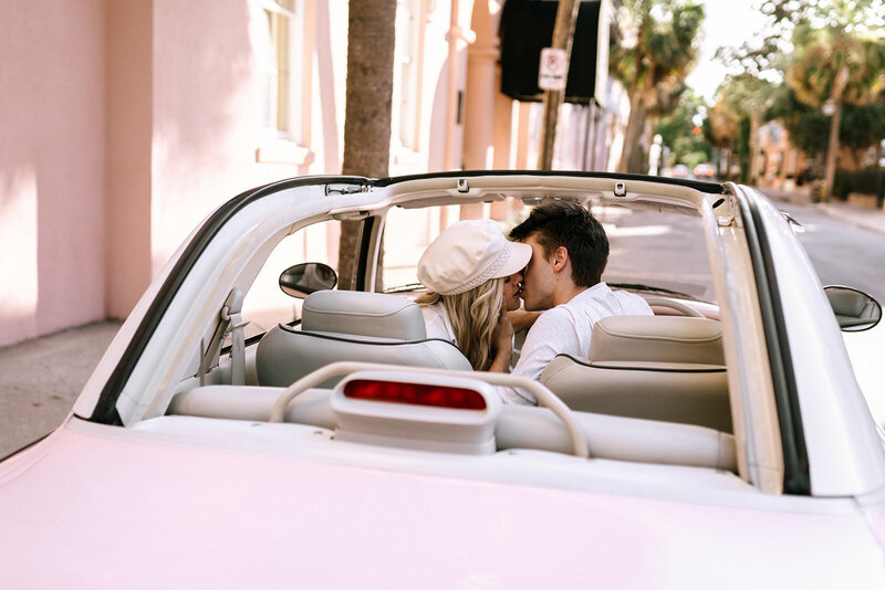 couple kissing in pink figgy car rainbow row