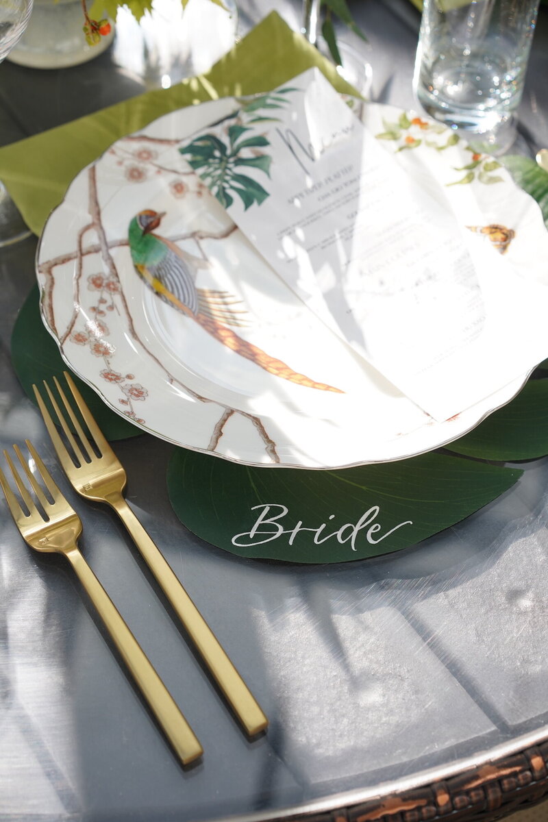 Calligraphy names written on monstera leaf place mats