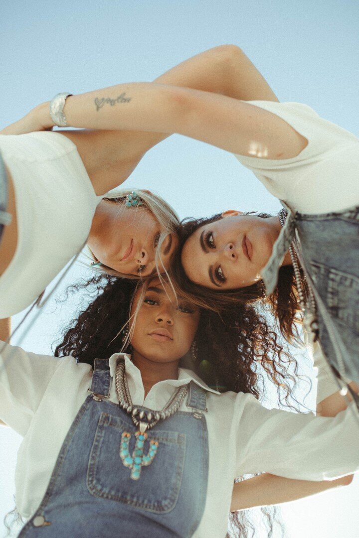 three women looking down at the camera