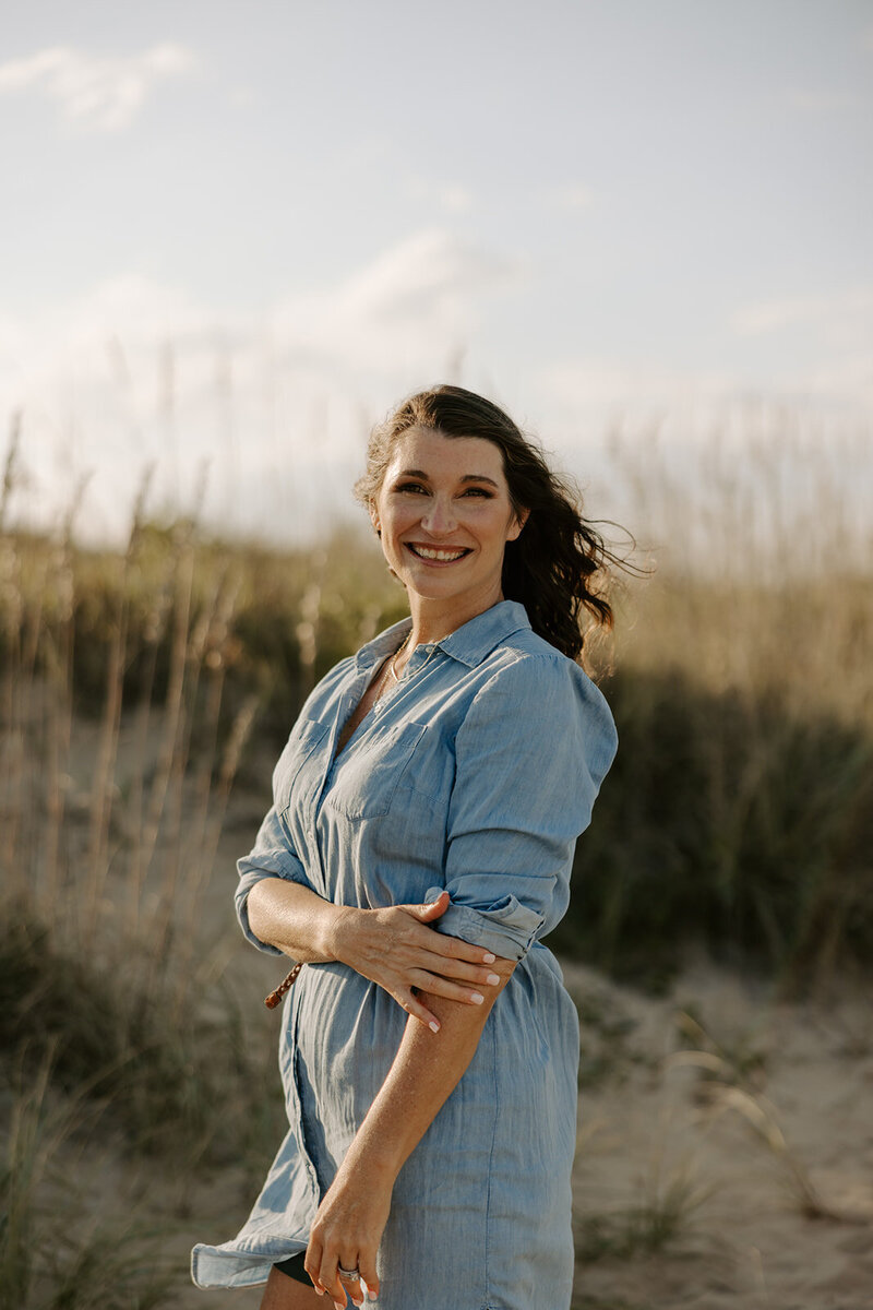 Therapist sitting on chair smiling next to Golden Retriever
