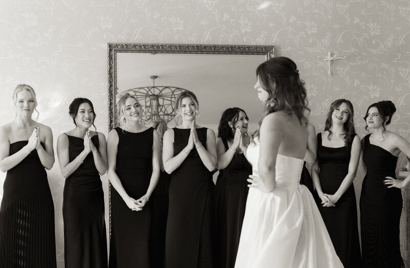 Bridesmaids joyfully fawning over the bride at DuGaren Venues & Vineyards, capturing a heartfelt pre-ceremony moment