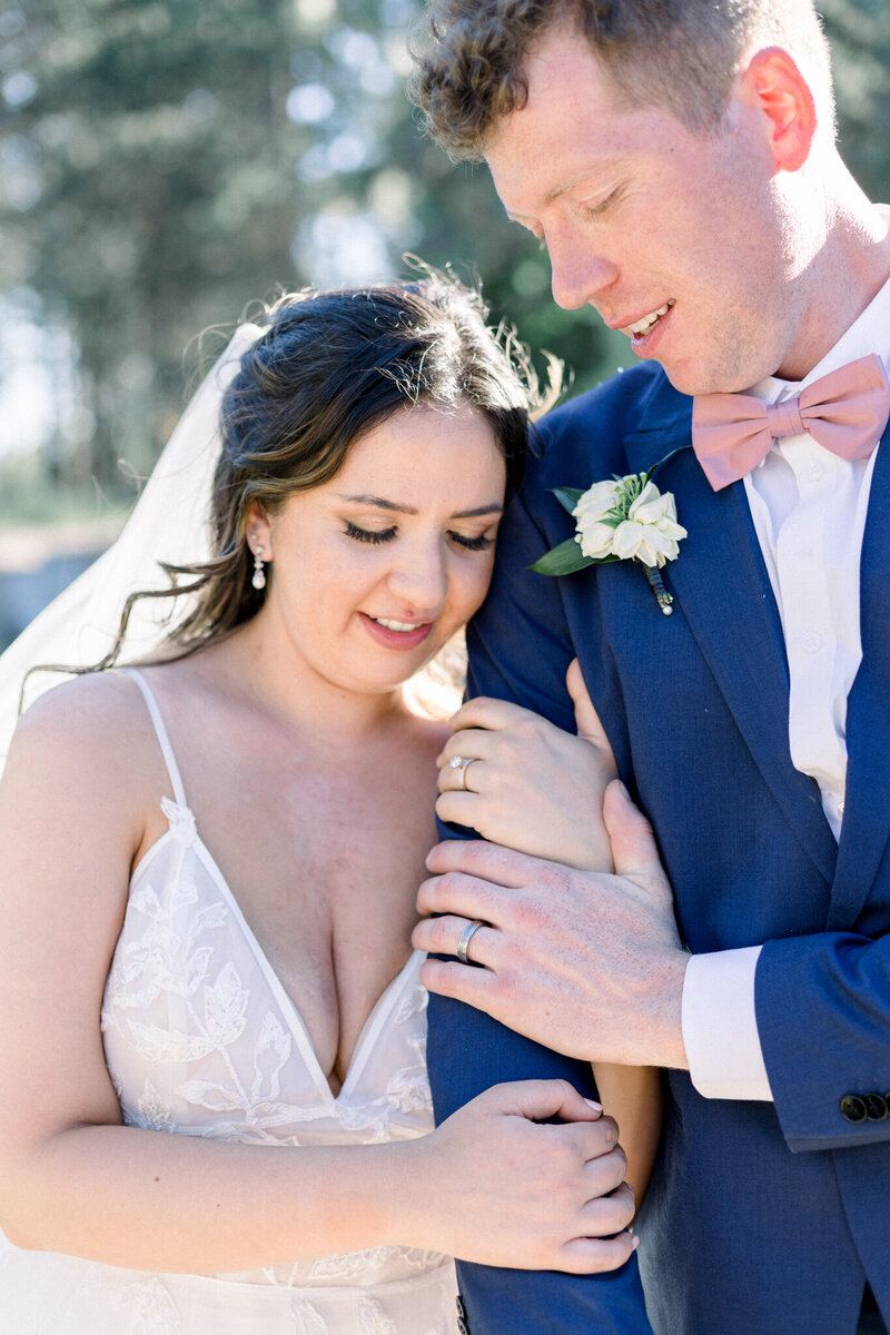 Bride and groom sharing a kiss at the end o the aisle taken by Spokane Wedding Photographer