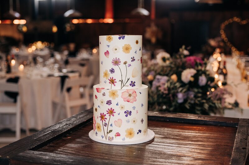 white two tier wedding cake with pressed edible florals on it in darfield christchurch