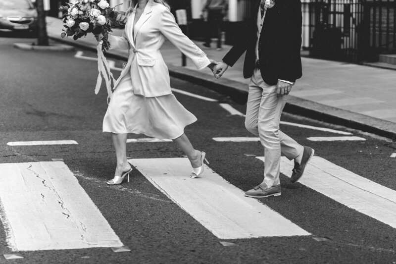 bride and groom walking across road