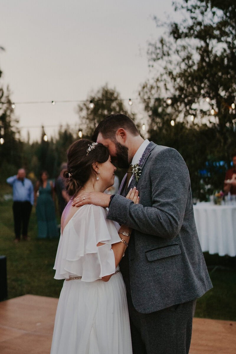 bride and groom dancing close