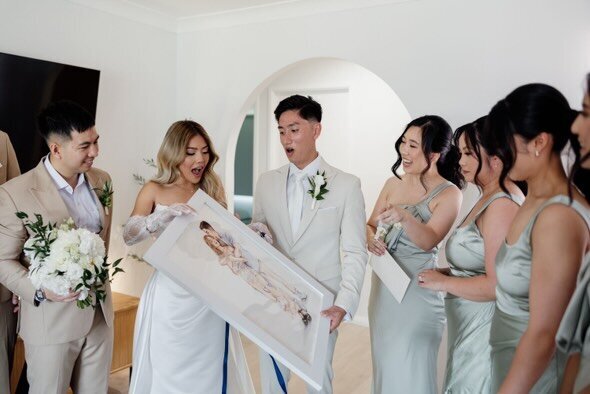 bride-and-groom-receiving-commissioned-portrait-as-a-wedding-gift
