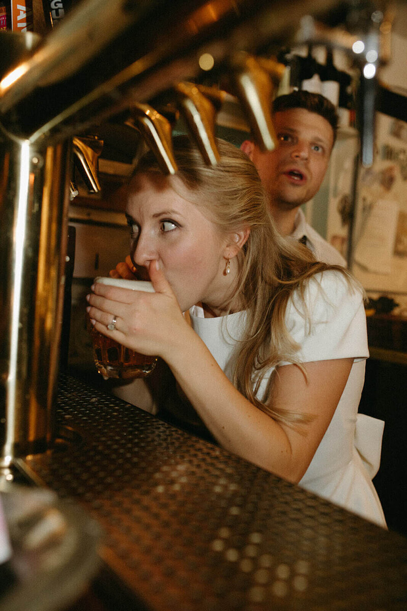 Bride drinks a beer on her wedding day in San Francisco