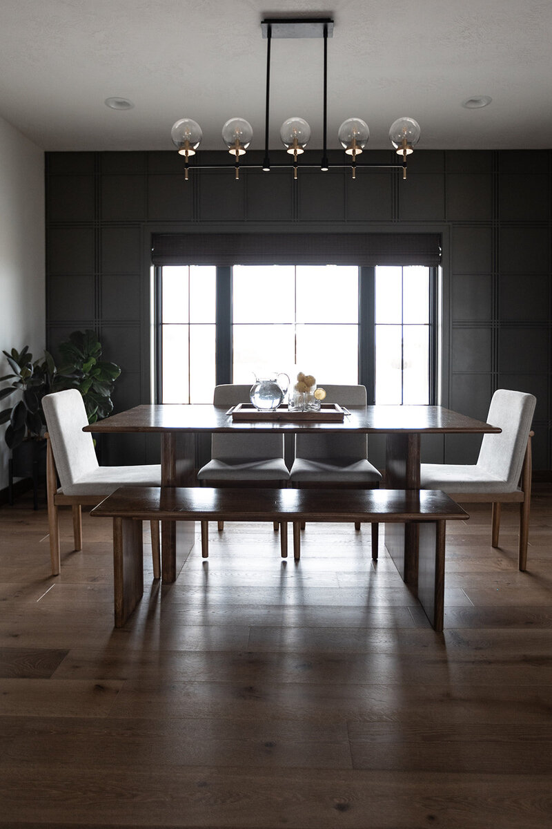michele rosenboom design brown st new build dark accent wall with dining table and wood floors