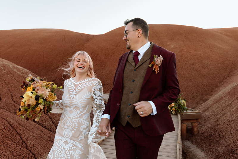 Couple running along a boardwalk at Painted Hills.