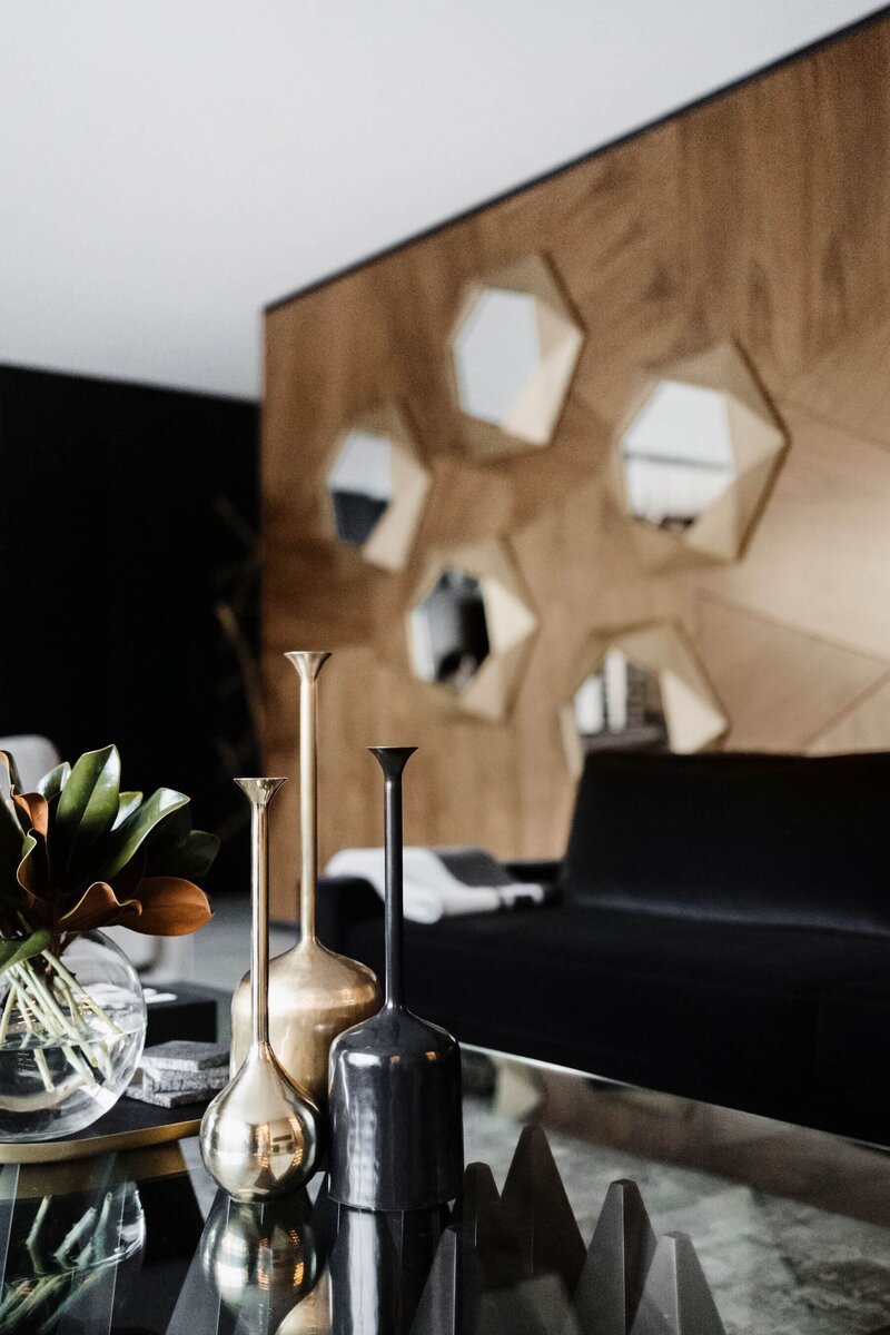 A walnut feature wall with accent brass and gold mirrors. 