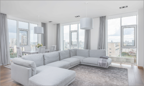 Luxury corner unity apartment with three casement windows bordered by large glass picture windows that line the corner of the apartment.