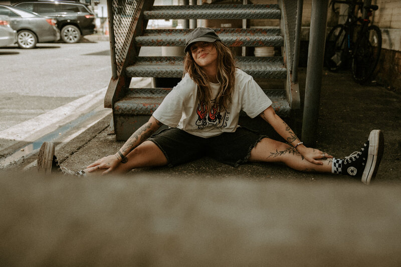 Editorial grunge street-style portrait in stairwell, cinematic film & Super 8 moody tones