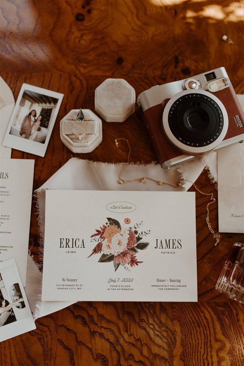 Orange and white wedding invitations with red envelope on a round woven basket
