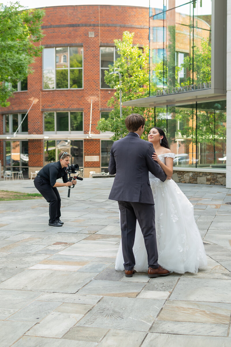 A videographer recording a newlywed couple 